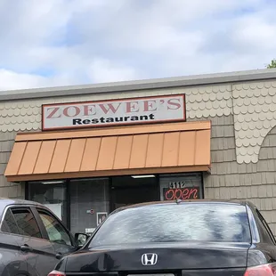 two cars parked in front of the restaurant