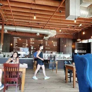 a woman walking through a cafe