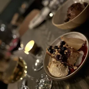 a table with desserts and wine glasses