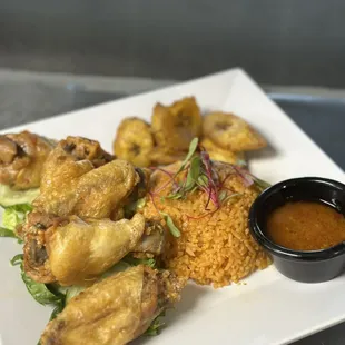 Chicken Wings and Jollof Rice with side fried Plantains and Hott sauce