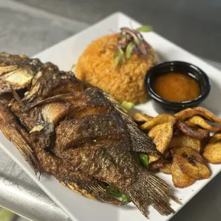 Fried Fish meal with sweet Plantains and Jollof Rice. Side special Sauce