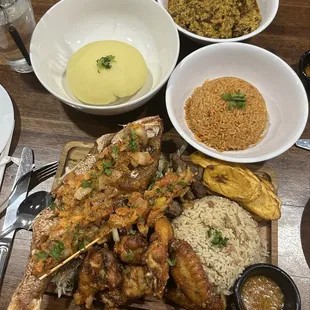 Dry rice supreme w/red snapper, plantains, steak skewer, chicken wings, jollof rice, fufu and egusi soup.