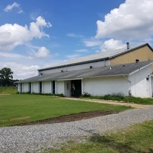 a white barn with a brown roof