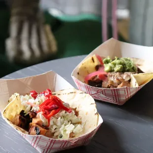 two tacos on a table