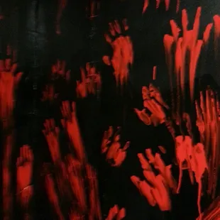 a group of bloody hands in a dark room