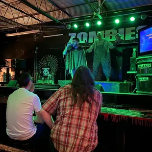 a man and a woman sitting at a bar