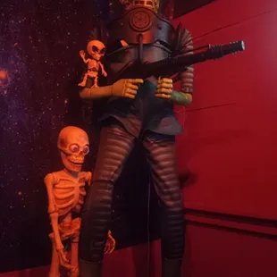 a statue of a man with a gun and a skeleton