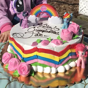 a girl holding a birthday cake