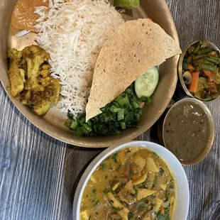 a bowl of food and a plate of rice