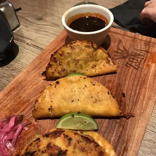 Queso Birria tacos with a very oily red sauce.  still not sure what that was.