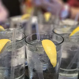 glasses of water with lemon wedges