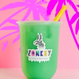 a green drink with a zebra sticker on it