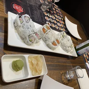 a plate of sushi and a bottle of wine