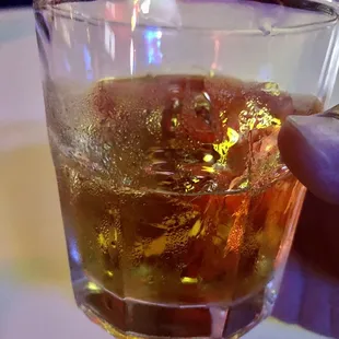 a person holding a glass of beer