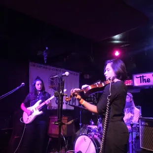 a woman playing violin and a man playing guitar