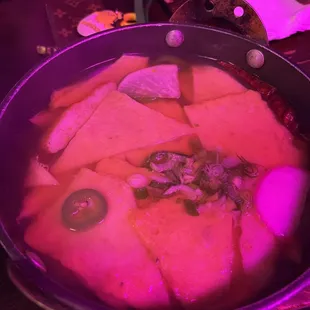 a pot of soup with meat and vegetables