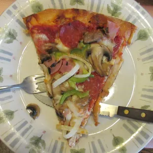 An average-sized slice of the Medium Deluxe Pizza.