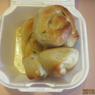 Garlic knots in a garlic/butter sauce.