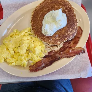 Pancakes with scrambled eggs and bacon
