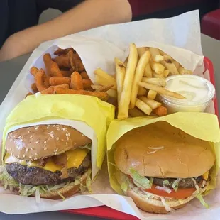 California cheeseburger with fried zucchini on the left and a Junior cheeseburger with fries on the right.