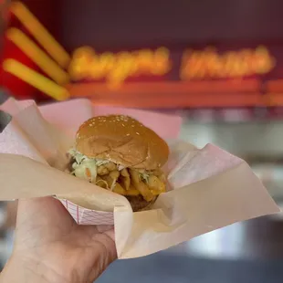 a hand holding a sandwich