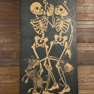 two skeletons and a cat