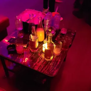 a table with drinks and candles