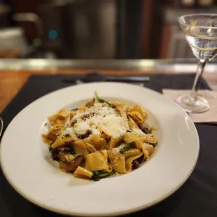a plate of pasta and a glass of wine
