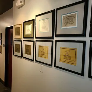 a hallway with framed and unframed artwork
