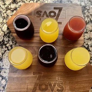 a variety of beverages on a cutting board