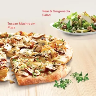 a pizza and a salad on a table