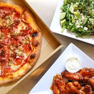 a pizza and a salad on a table