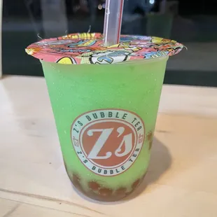 Frozen green apple tea with strawberry popping bubbles.