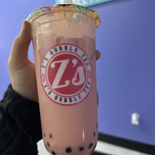 a hand holding a cup of bubble tea
