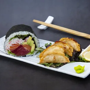 a plate of sushi with chopsticks