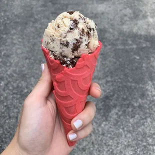 a hand holding an ice cream cone