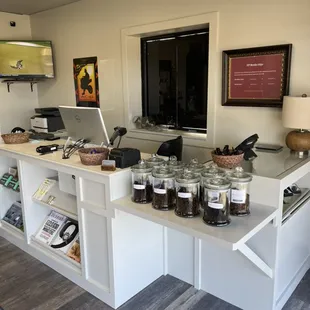 Front of store retail counter with pipes, pipe tobacco, and accessories.