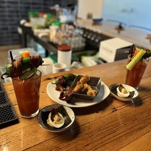 a wooden table with plates of food on it