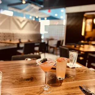 two cocktails on a wooden table
