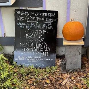 a sign and a pumpkin
