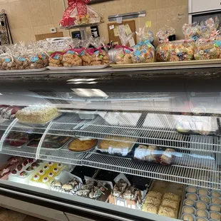 Display case of cakes and desserts, including Gluten Free desserts.