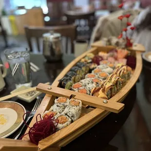 a wooden boat with sushi on it