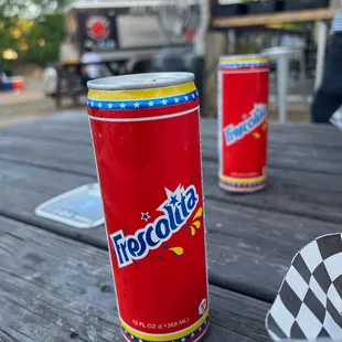 a can of soda on a picnic table