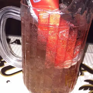 a pitcher of soda and strawberries
