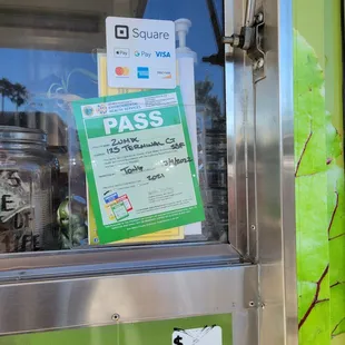 a pass sign in the window of a food truck