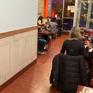 people sitting at tables in a restaurant
