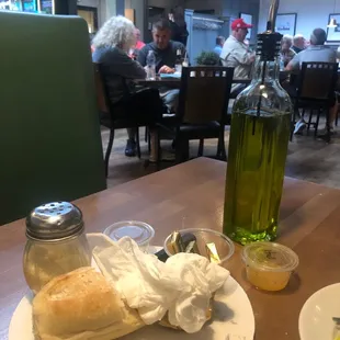a sandwich and a bottle of olive oil
