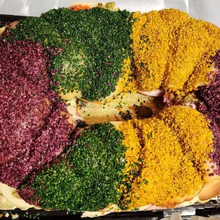 Muffaletta king cake. Dyed sesame seeds. Pretty pn par with thr best in the city!