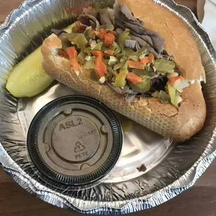Half of the Hot Italian Beef sandwich with side of au jus