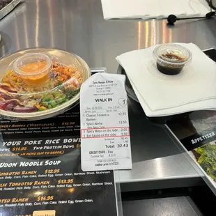 Our receipt showing that they charged us $4 (2 per extra sauce), and just how tiny amount of sauce is in that container that is worth $2.